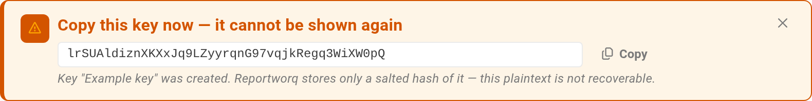 The one-time rotation-key reveal callout shown right after Generate, reading "Copy this key now, it cannot be shown again", with the key value, a Copy button, and a note that Reportworq stores only a salted hash and the plaintext is not recoverable