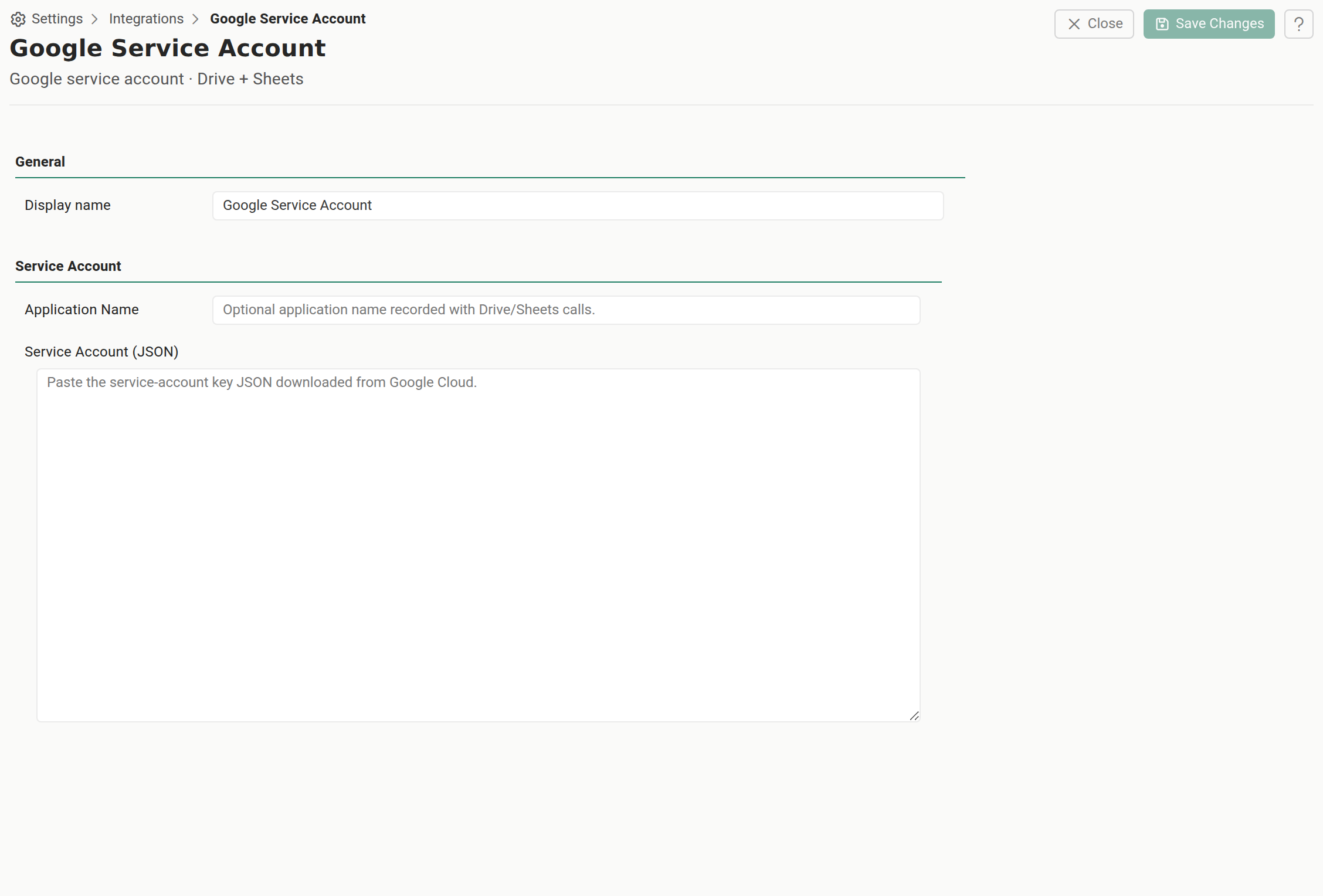 The Google service account credential editor in Settings, Integrations, Shared Credentials. A General section holds a single Display name field. Below it a Service Account section holds an optional Application Name field prompting "Optional application name recorded with Drive/Sheets calls." and a large multi-line Service Account (JSON) field prompting "Paste the service-account key JSON downloaded from Google Cloud." Close and Save Changes sit in the toolbar.